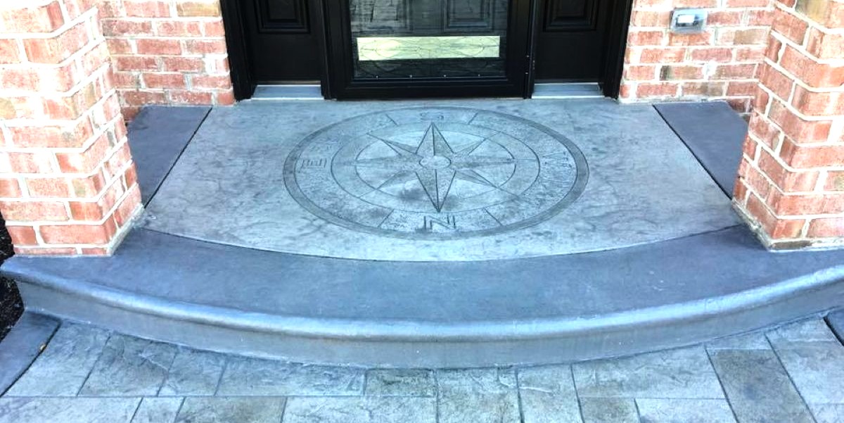 Compass medallion engraved into a decorative concrete front entry