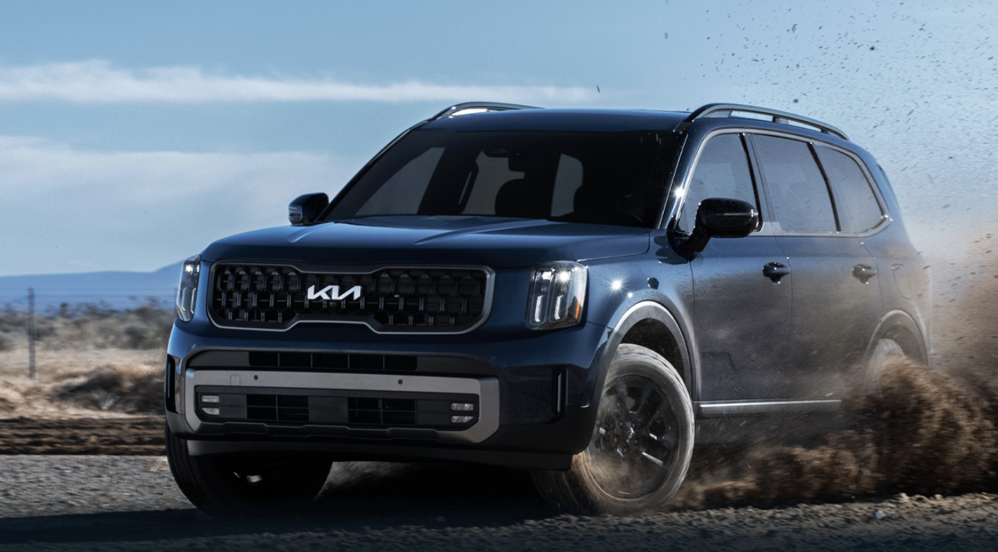 Kia Telluride parked in a scenic outdoor setting, showcasing its bold design and spacious three-row interior