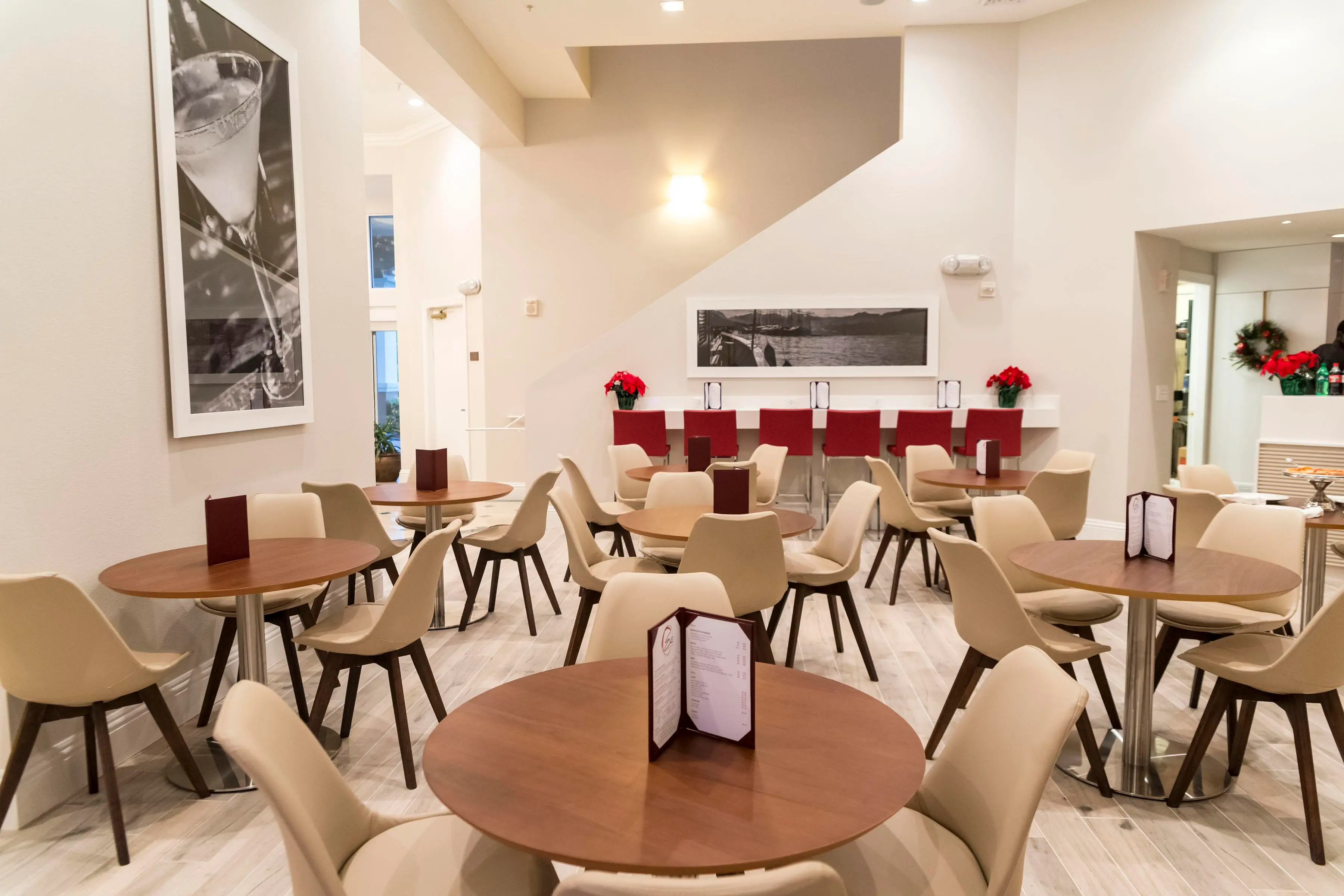 a dining area with round tables and chairs