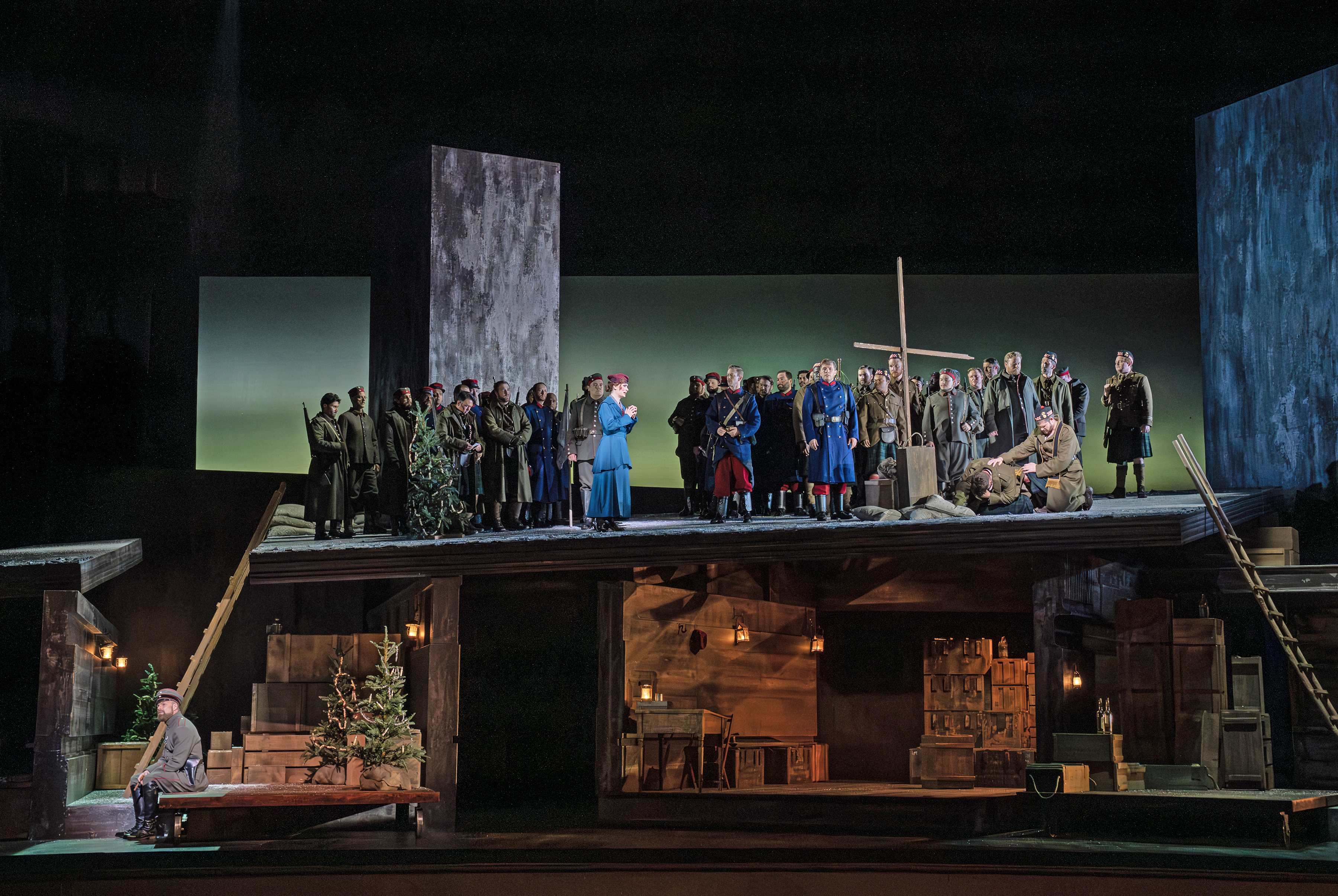 Stage scenery of people gathered around a giant cross.