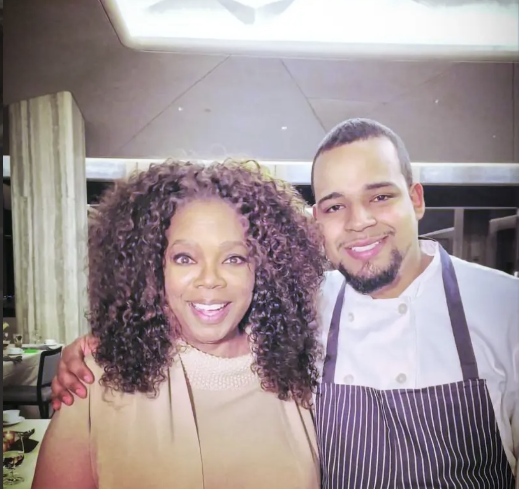 Chef pictured with Oprah at a culinary event