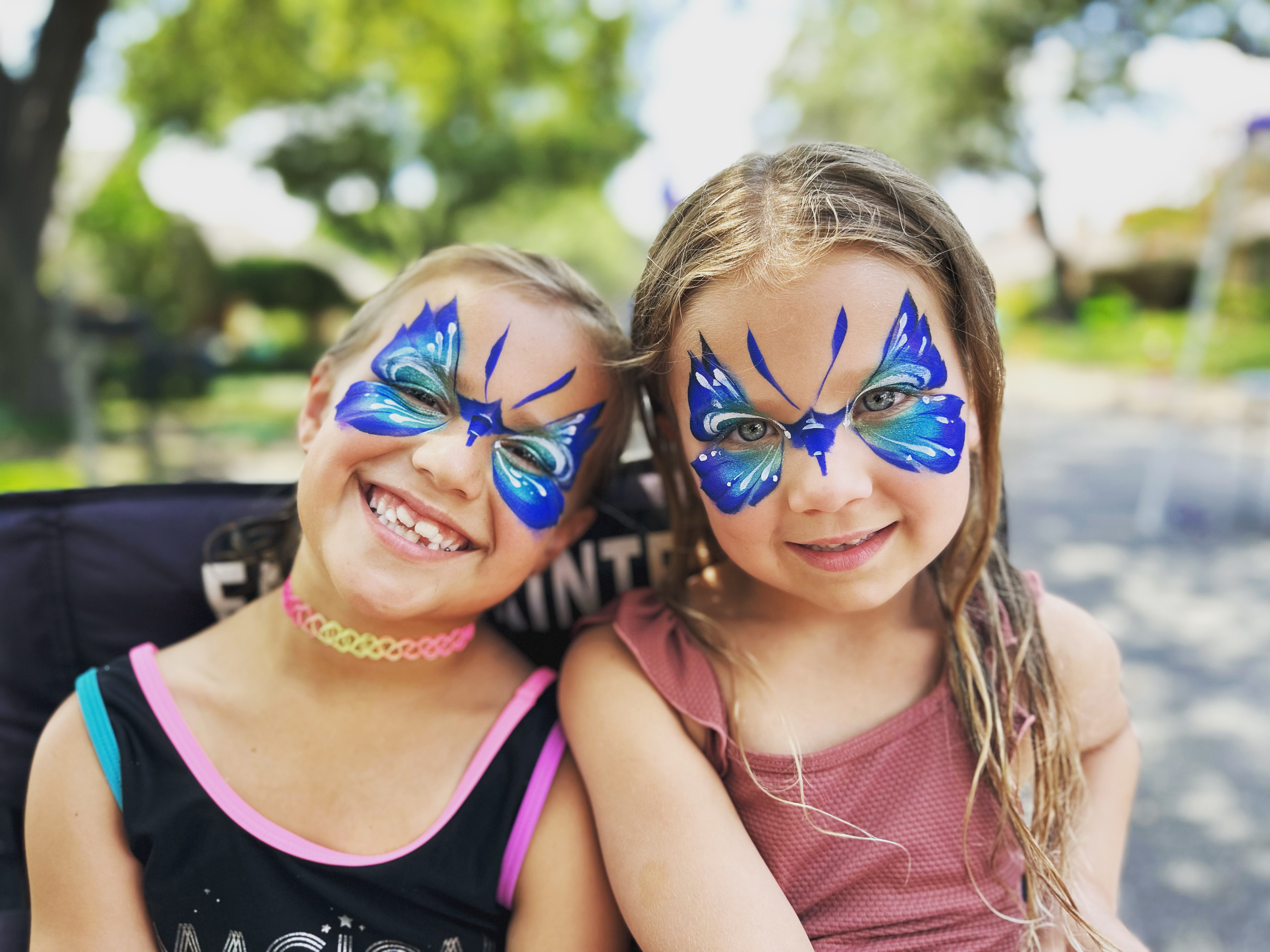 Children with colorful face painting at a Dallas-Fort Worth party