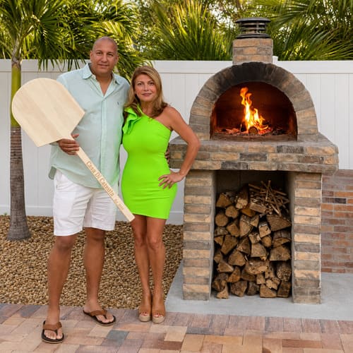 Catania outdoor refractory brick pizza oven in a transformed backyard